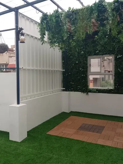 This renovation was for a passionate mother who had clear ideas for her space. We added a green wall, hanging plants from the pergola, and a mix of turf and deck flooring to create her dream terrace garden.