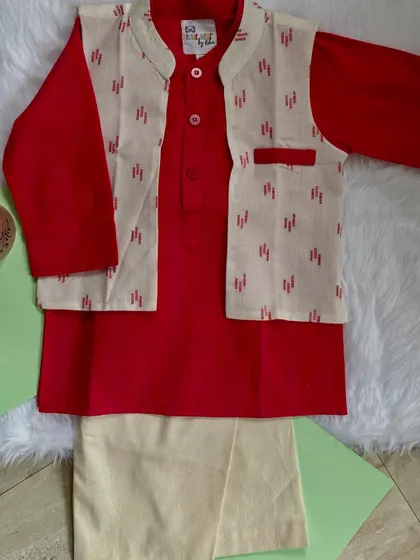 This elegant red and ivory ensemble is perfect for celebrations. The solid red kurta is paired with a subtly printed Nehru jacket, offering a look that is both traditional and modern.