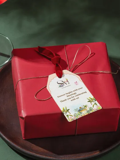 A personalized gift tag adds that final, thoughtful touch to your wedding favors or welcome hampers. This tag, tied with a beautiful ribbon, carries the couple's wedding logo and a sweet thank you message for their guests.