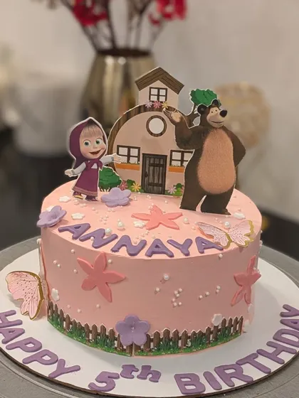A lovely Masha and the Bear themed cake for a 5th birthday. The design includes edible images of the characters against a charming woodland scene.