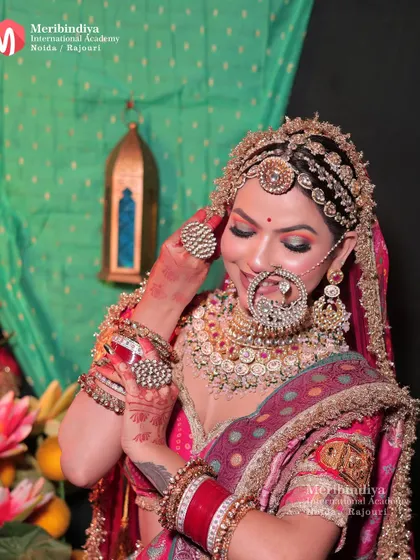 A candid shot of a traditional Rajasthani bride, highlighting the elaborate 'borla' and 'sheeshpatti' integrated into the hairstyle.