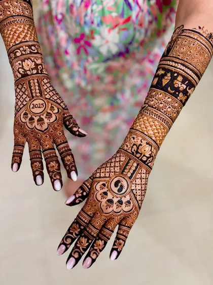 An angled view of the 2025 baby shower mehendi, showing the detailed bands on the forearm.