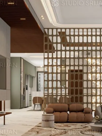 A decorative jali screen in the Model Town lobby acts as a room divider, separating the seating area from the kitchen while allowing light and views to pass through.