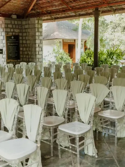 The simple elegance of the chair decor ensures the focus remains on the natural beauty of the venue and the ceremony itself.