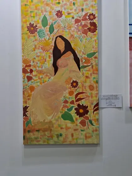 A beautiful painting by Sinal Bajaj celebrating femininity, with a woman surrounded by a tapestry of flowers and patterns.
