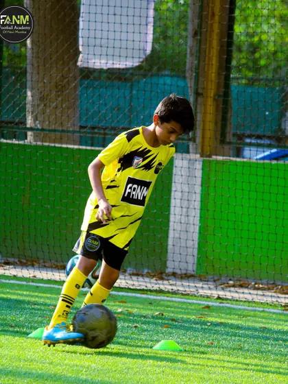 A player practices dribbling with a weighted ball, a technique used to improve strength and control.