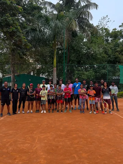 A group photo of our athletes and coaches after a collaborative on-court fitness session with a partner tennis academy. This highlights our engagement with the broader sports community.