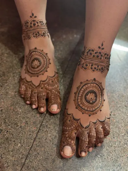 A lovely feet design with a central lotus mandala and a detailed ankle band.