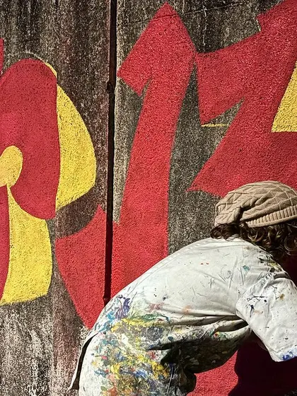 Me in action, filling in the bold red of my Devanagari tag.