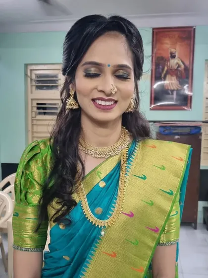 A smiling bride-to-be, looking radiant and happy. The makeup is soft and glowing, perfect for her engagement day.