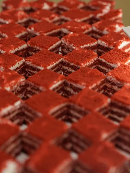A geometric display of our red velvet petit fours. The vibrant colour and precise, uniform squares create a visually striking and elegant presentation on the dessert buffet.