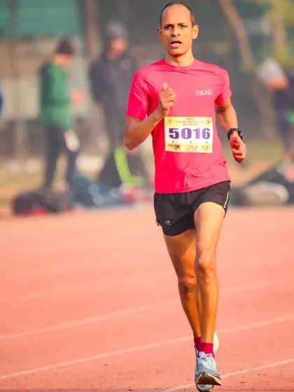 A runner in full flight during the 25 laps of the 10,000-meter track event. He ran strong from the start and secured a gold medal in his age category.