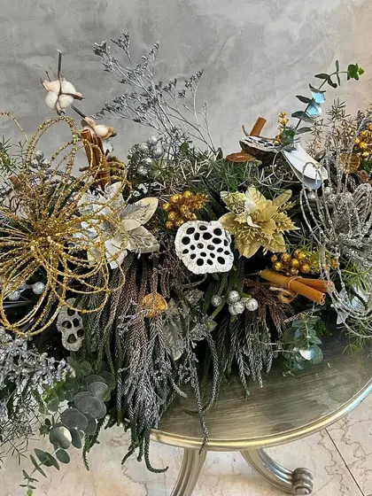 This "Glistening Silver Lace" arrangement was designed for a Christmas party. I used sparkly silver and gold elements, dried foliage, and festive greens to create an elegant and celebratory floral runner.