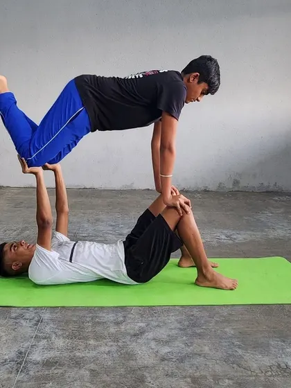 This dynamic "throne" pose variation showcases the power and stability of the base, supporting the flyer with ease.