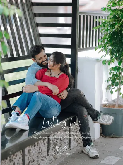 The couple cuddling on a bench, a perfect picture of "Lasting Love."
