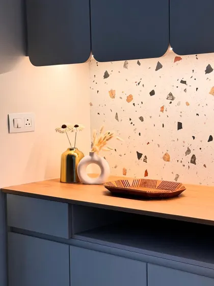 This little corner is designed to feel calm and grounded. A terrazzo backsplash is paired with a wooden countertop and minimalist blue-grey cabinets, creating a quiet elegance with soft, under-cabinet lighting.