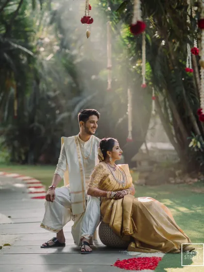 A dreamy, sun-drenched portrait of the couple in a garden setting. The soft light filtering through the trees adds a magical quality to this romantic shot.