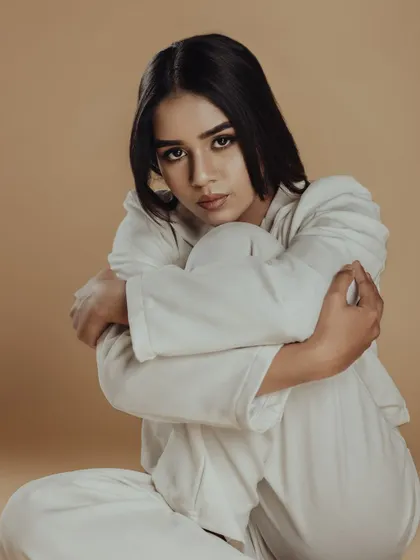 A close-up portrait from the shoot. The smokey liner and defined brows give intensity to the eyes, creating a powerful and modern look.