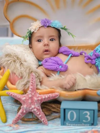 Another beautiful shot of the alert baby mermaid, capturing her wide-eyed wonder.