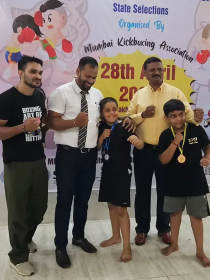 Proud coaches with our young medal winners at the Mumbai Kickboxing Championship. We guide them every step of the way, from training in the gym to celebrating their victories.