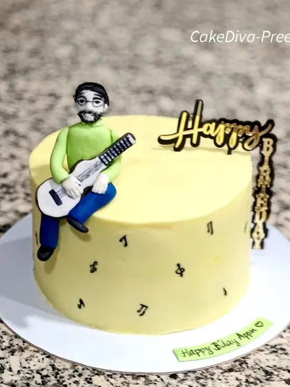 A simple yet personal cake for a guitarist. It features a custom fondant figurine of the birthday person with his guitar, sitting atop a delicious pineapple ganache cake.
