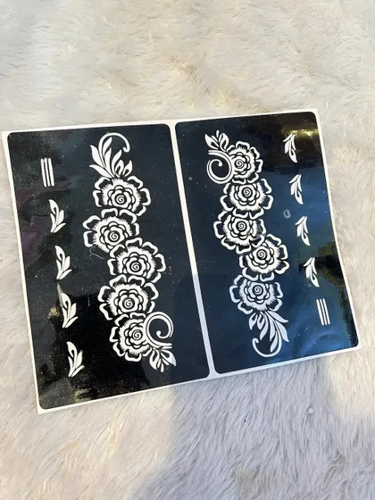This stencil sheet features a classic floral vine design that can be used on the fingers or as a trail down the hand. The set includes two symmetrical vines, perfect for decorating both hands.