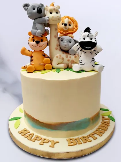 We stack up the fun with this cute animal birthday cake. A tower of friendly, handcrafted animals, including a tiger, koala, giraffe, and elephant, creates a playful and unique topper for a simple yet charming birthday cake.