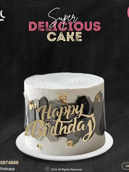A chic and modern birthday cake. This design features a black and grey watercolor effect on white buttercream, finished with a bold, golden "Happy Birthday" topper.