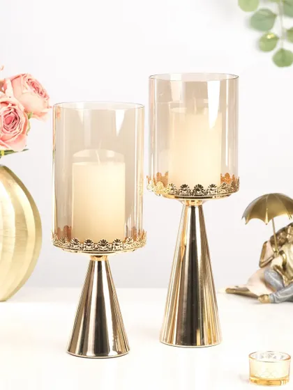 A product shot of elegant glass and gold candle holders, perfect for modern Diwali home decor.