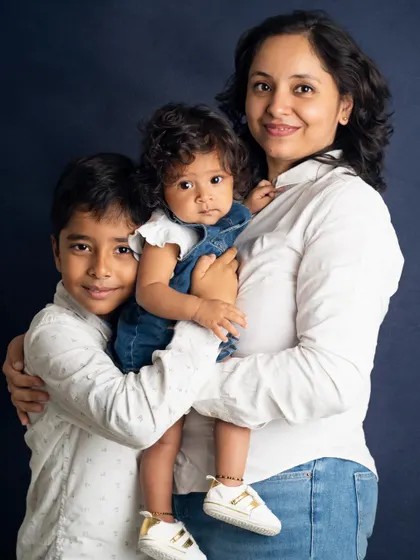 A mother holds her two children, a son and a baby daughter, in a warm embrace. We are experienced in photographing families with kids of different ages, ensuring everyone feels included.