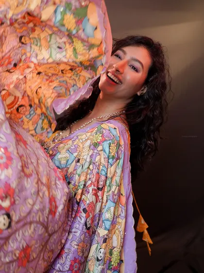 A joyful, candid moment from the same shoot. The genuine smile and movement of the fabric make this a very lively photo.