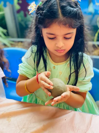 A lovely, focused moment from our Ganesha workshop. The natural, green background complements the eco-friendly clay activity perfectly.