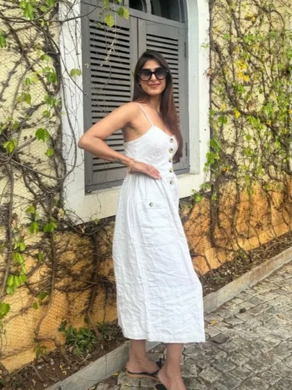 Personal style is forever. It's about finding what makes you feel powerful and confident. Here, I'm wearing a simple white linen dress that is perfect for a summer day, proving that elegance is often in simplicity.