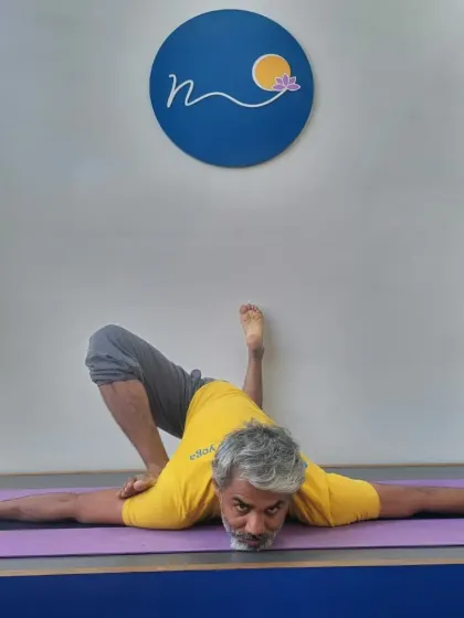 This hip-opening posture, a variation of Parsva Bhuja Dandasana, targets deep external rotation of the hip. In my workshops, I guide students on how to safely enter such poses to increase mobility and release tension.