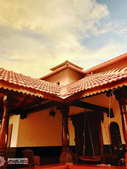 The exterior of the Udupi house, showing the intricate woodwork on the eaves of the Mangalore tile roof. These details are characteristic of the coastal Karnataka architectural style.