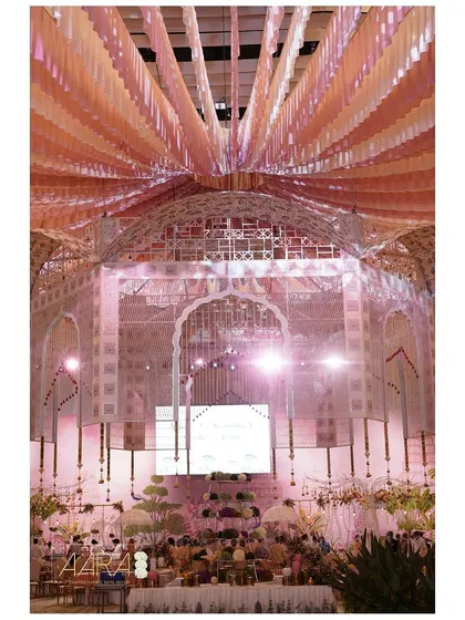 A floating floral flair. This central installation of cascading pink and orange ribbons created a stunning visual centerpiece for an expansive dining hall.