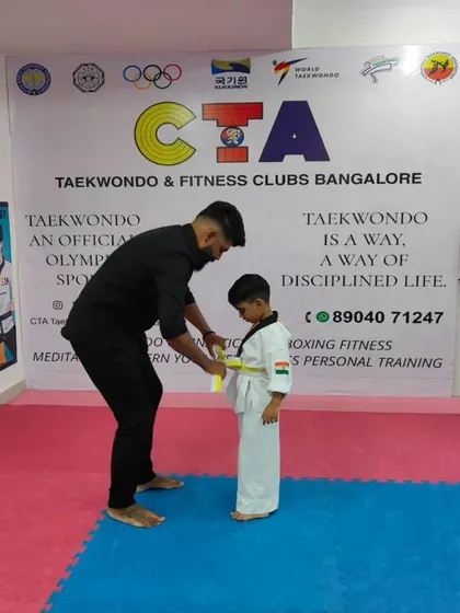 Tying a yellow belt.