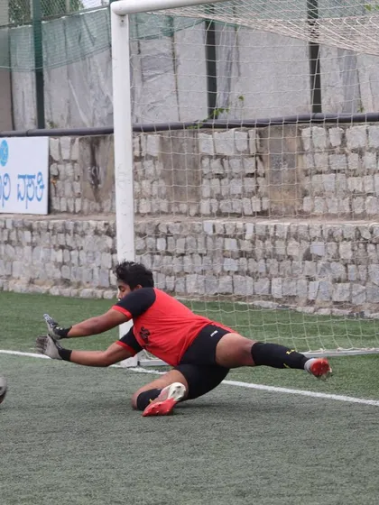 A goalkeeper diving to make a save during a training drill. I provide specialized coaching for my keepers to sharpen their reflexes, positioning, and shot-stopping abilities.
