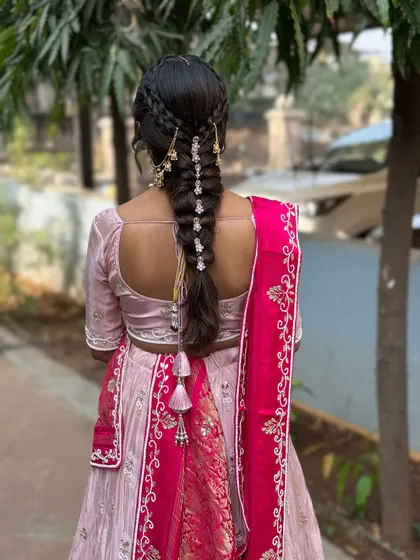 A view of the beautiful braided hairstyle for the Path Muhurat. The delicate accessories add a touch of elegance to the traditional look.