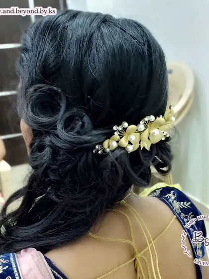 A duplicate of 22, this image provides another angle of the side-swept curls, showing the intricate placement of the curls and the beautiful hair brooch.