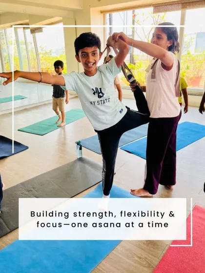 Building strength, flexibility, and focus, one asana at a time. A teacher provides gentle support to a young student in Natarajasana (Dancer's Pose) during our Bala Shivir.