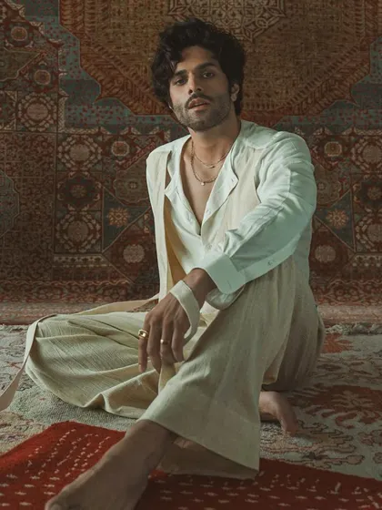 The full look of the layered white ensemble, showcasing its relaxed yet sophisticated silhouette. This is bespoke artistry that tells a story.