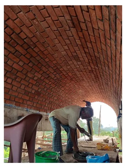 A worker inside one of the completed vaults, giving a sense of the scale and immersive quality of these 40-foot-long architectural elements.