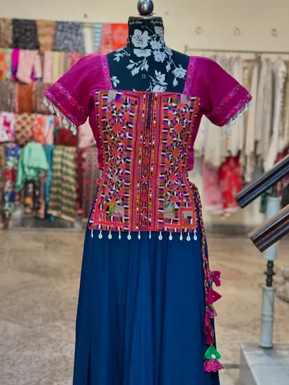 The vibrant colors and traditional embroidery make this a standout piece.