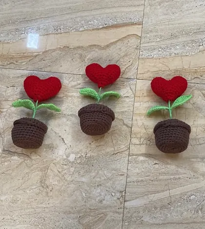 Five red heart pots ready to be shipped out for a bulk order. These are a popular choice for Valentine's Day, anniversaries, or just to spread love.