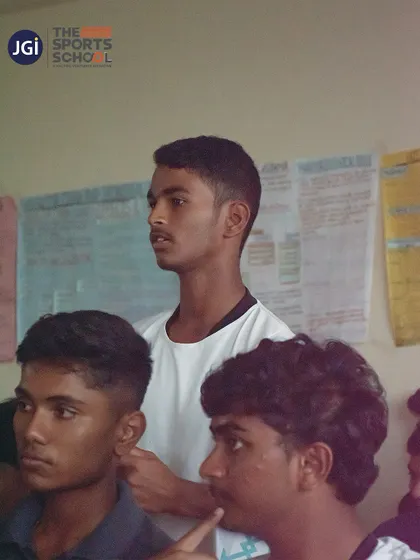 Students in a classroom setting, focused on a presentation about cricket laws and regulations.