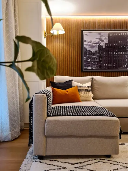 This peek into the media room shows the warm and cozy ambiance I created. The wood-paneled accent wall, soft backlighting, and comfortable sofa make it the perfect setup for family movie time or even a quiet meditation session.