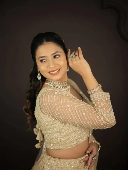 A side profile showcasing the full-sleeve embroidered blouse of this golden lehenga.