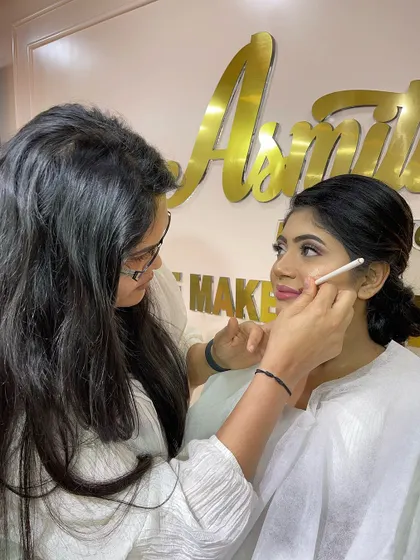 A student from the pro course carefully applying makeup. The focus and dedication in my classroom are what lead to incredible results.