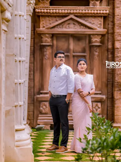 A stylish pose in front of a grand, carved wooden door, adding a sense of timeless elegance.